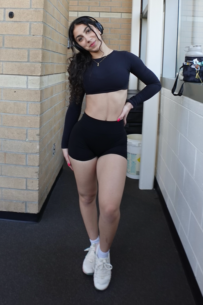 The coach is posing while wearing headphone.